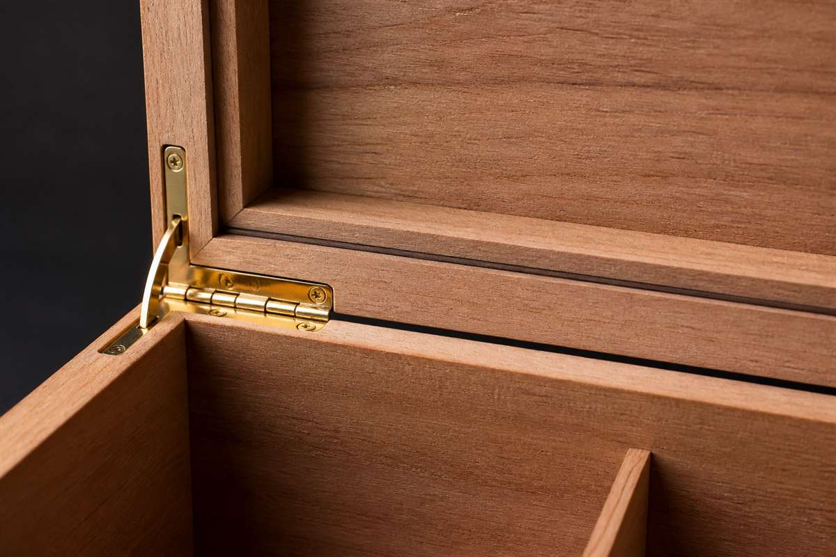 Close-up of cigar humidor lid alignment, hinge, and wood construction details.
