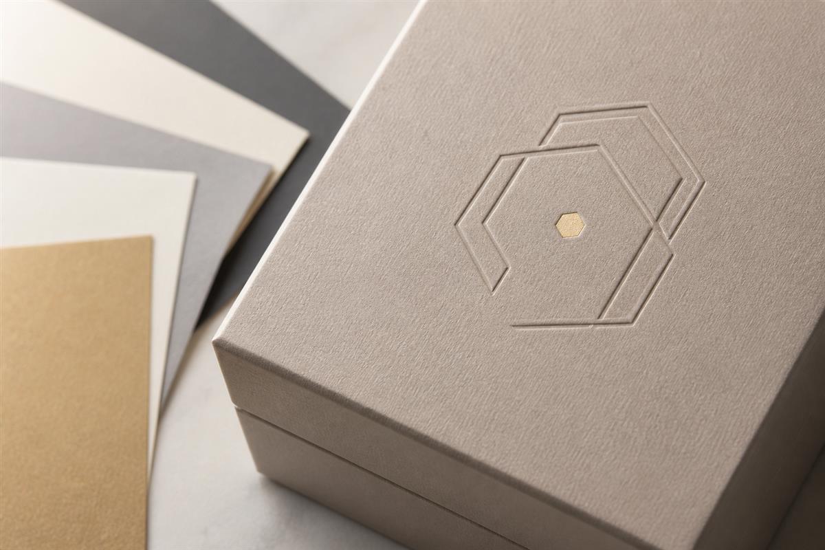 Close view of an unbranded jewelry box with paper texture and finish details.