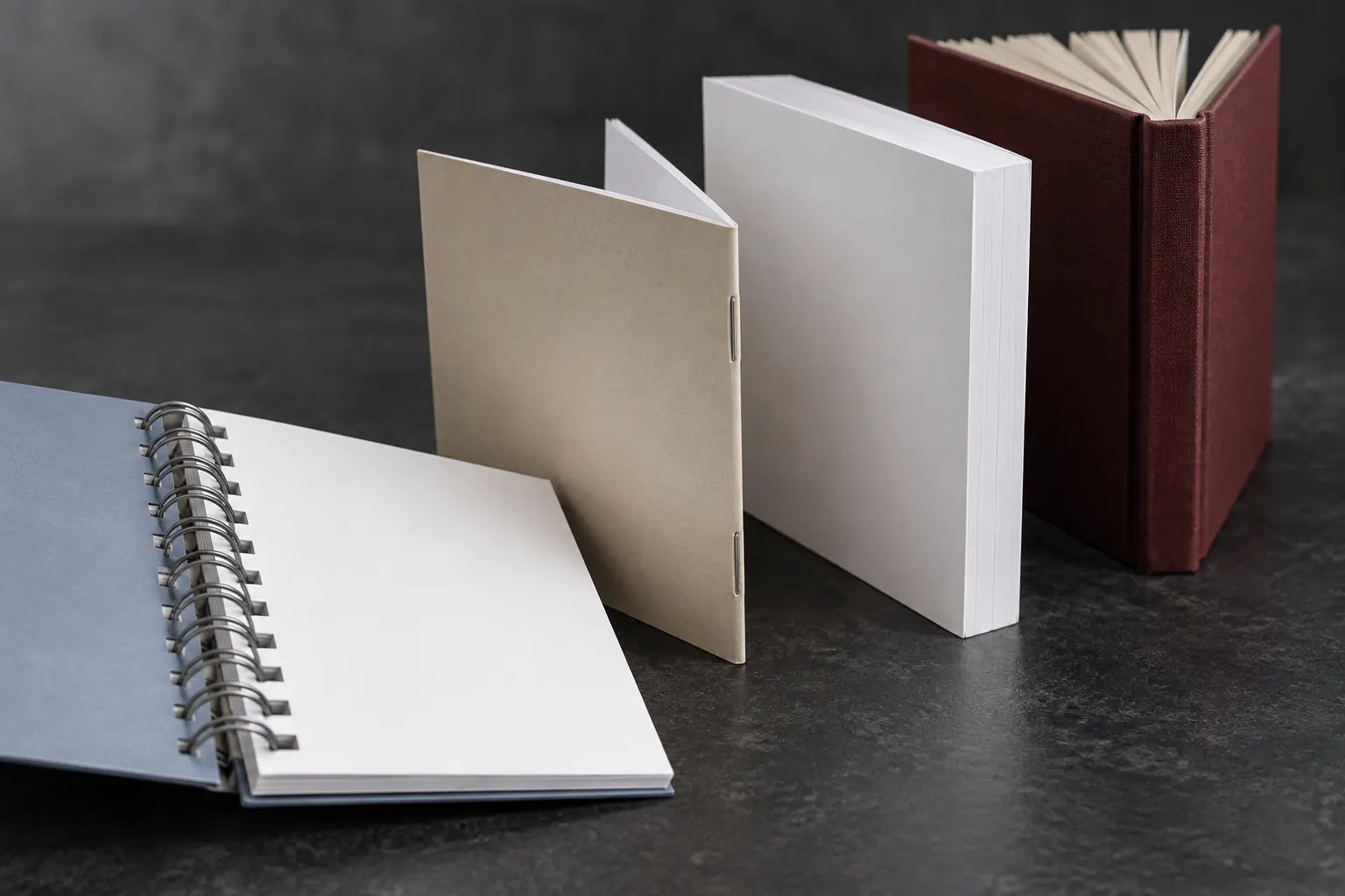 Wire-O, saddle-stitched, perfect-bound, and casebound book spines compared from a low angle