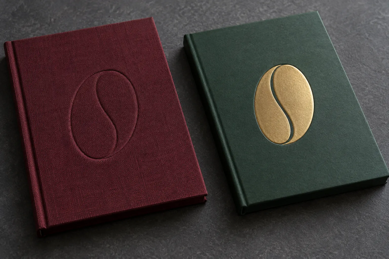 Blind debossed cloth sample beside gold foil relief on a green cover sample