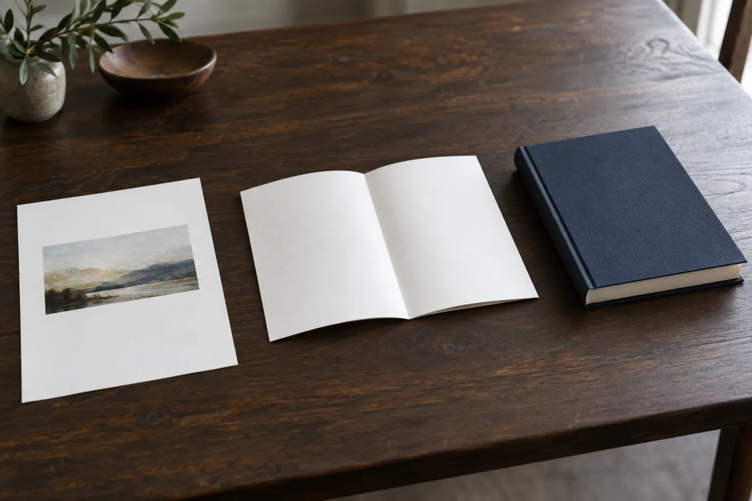 Flat printed proof sheets beside a folded signature and a bound book dummy