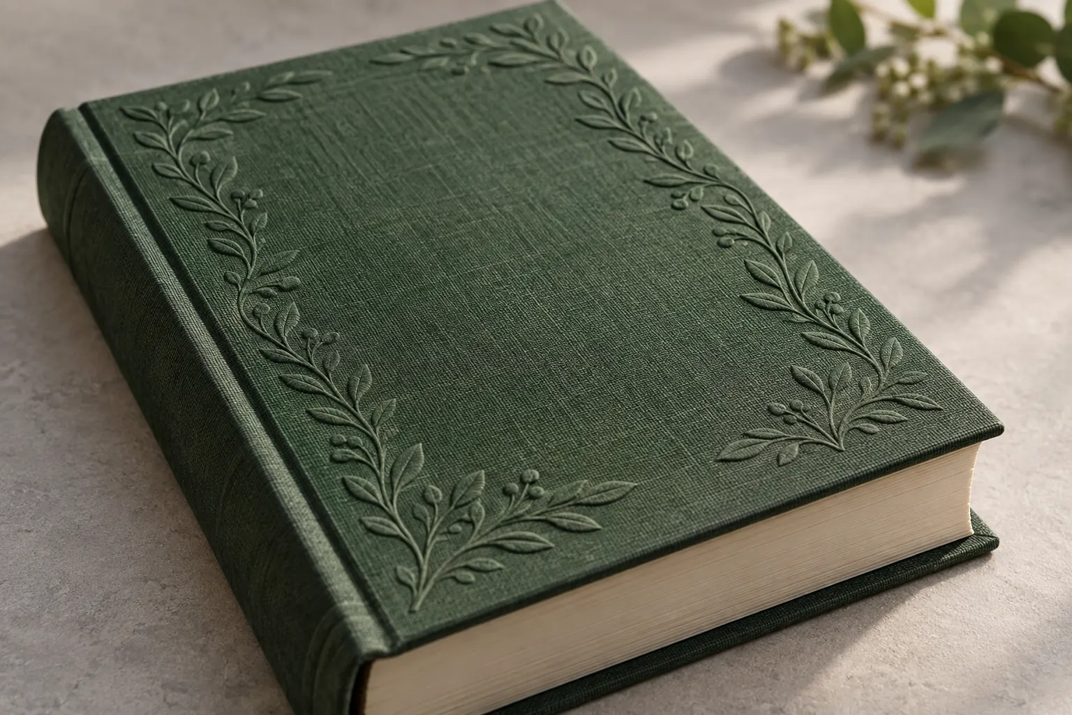 Raised botanical border embossed on a green book-cloth Bible cover