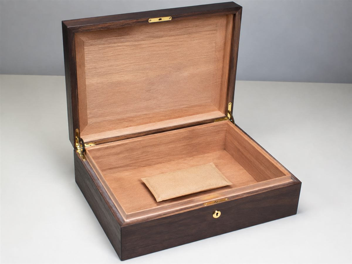 Empty wood-lined humidor with a conditioning packet before use