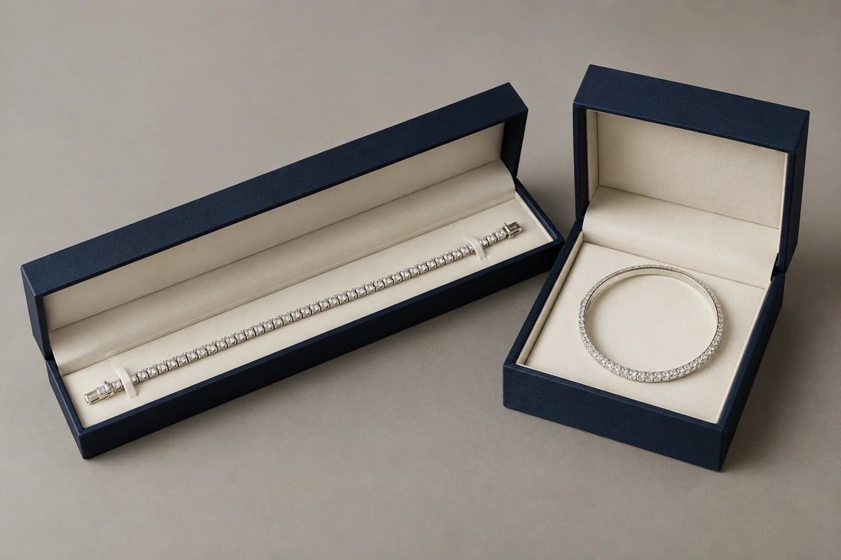 Long bracelet box beside a square box holding a rigid bangle