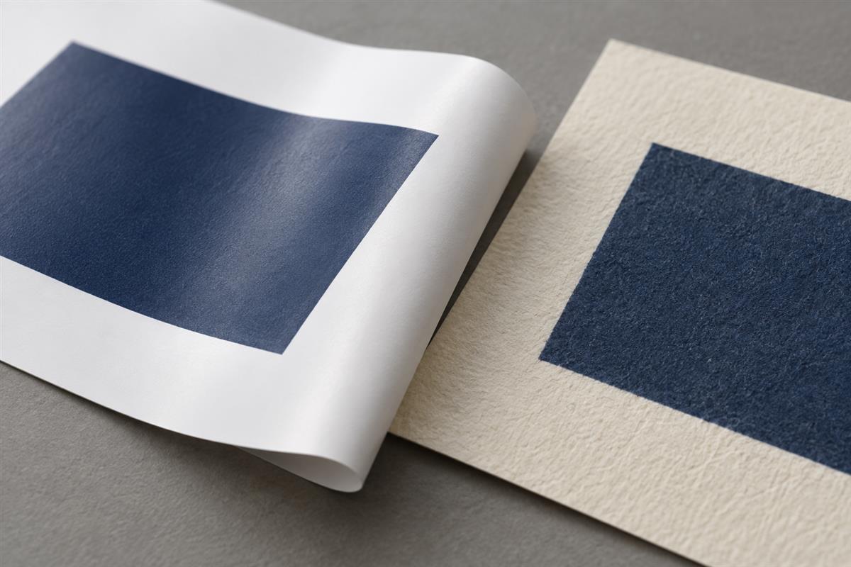 Smooth and textured paper swatches with navy printing