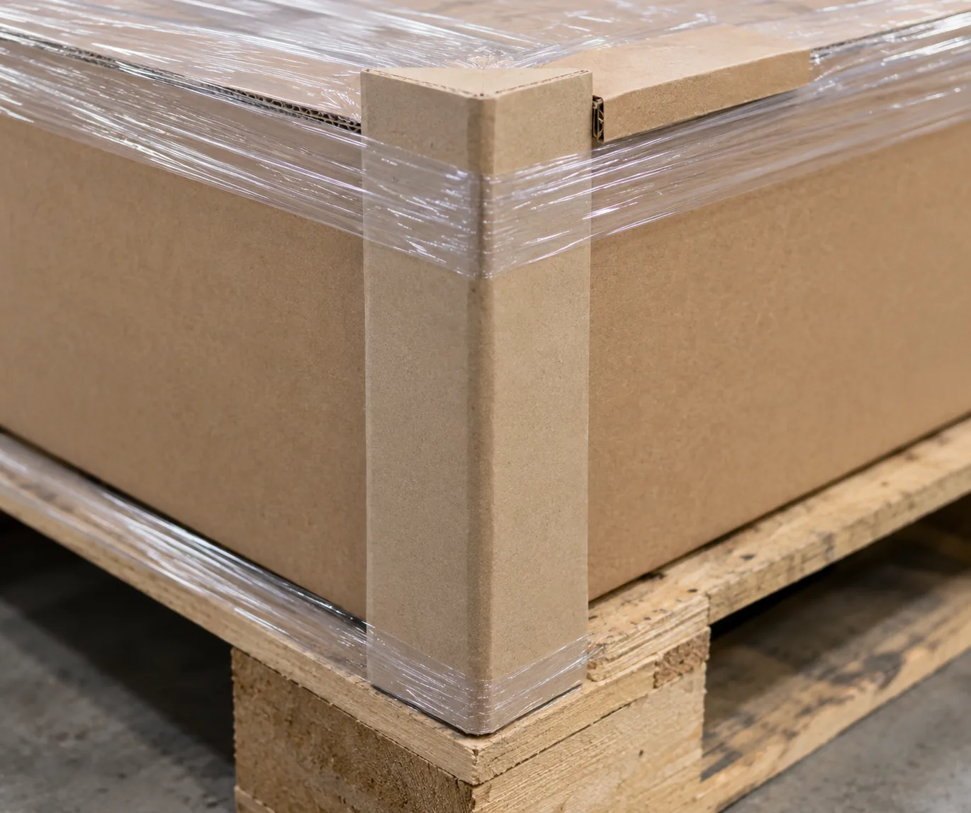 Wrapped cartons on a pallet with a cardboard corner protector